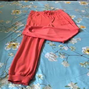 WOMEN’S size Medium orange eylelet pocket joggers . Orange coral color